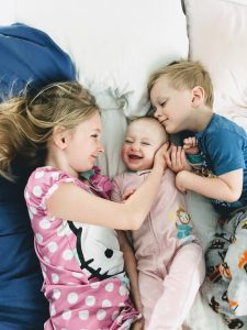 three kids in a bed